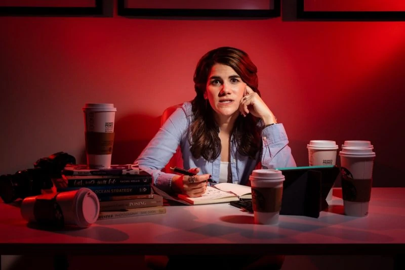 female freelancer working over desk with coffee