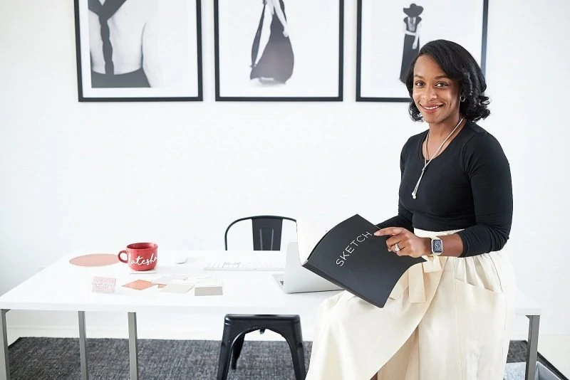 atlanta female entrepreneur reviews notebook at desk of white wall studio woodstock atlanta