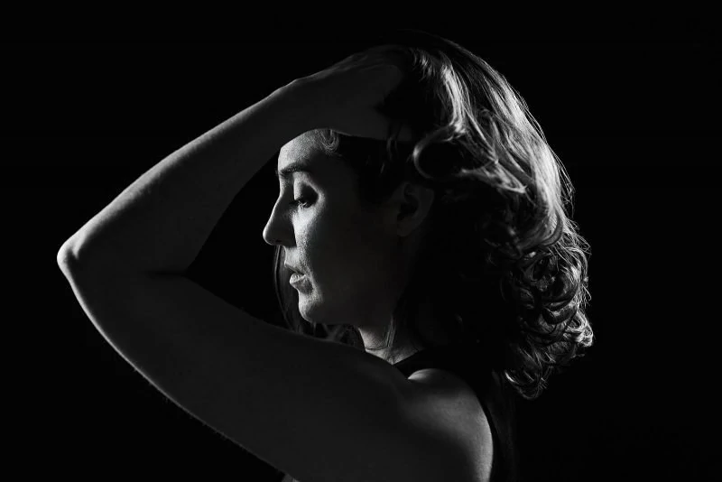 black and white rim lighting portrait of girl running fingers through hair atlanta studio