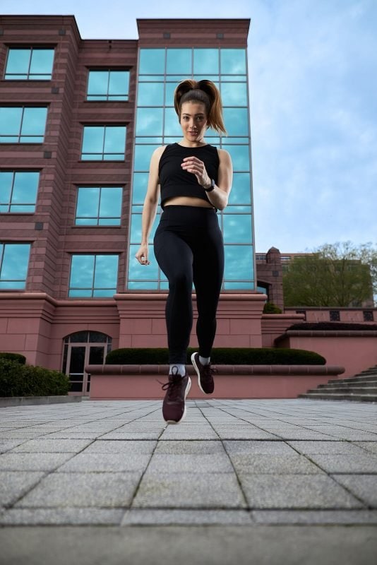 female athlete leaps in urban setting