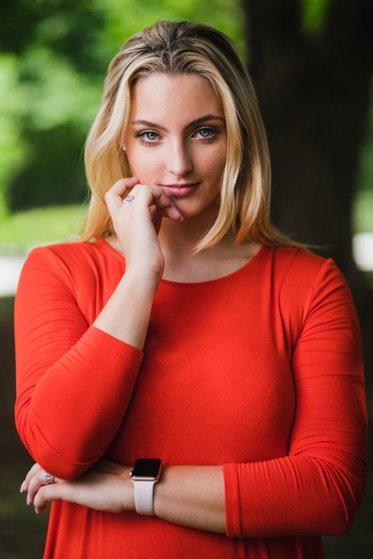 high school senior flash portrait in red dress with arms crossed