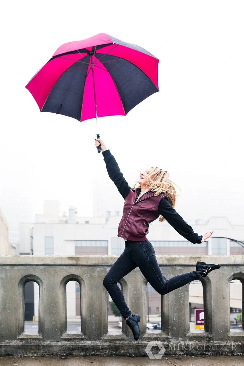 girl leaps with umbrella for rainy photoshoot in downtown atlanta