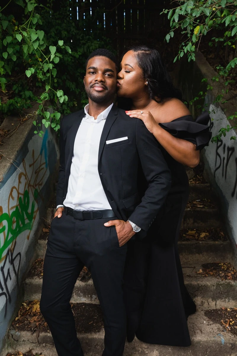 couple kisses on urban stairs for engagement session in Atlanta Old Fourth Ward