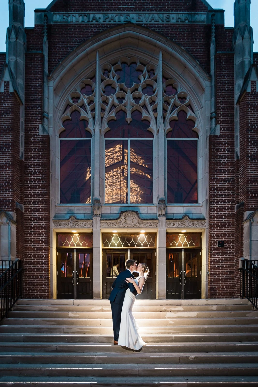 Groom dips and kisses bride on steps at Agnes Scott wedding