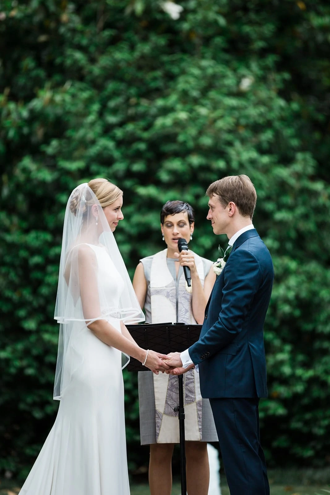 Atlanta wedding ceremony bride and groom exchange vows at Agnes Scott College