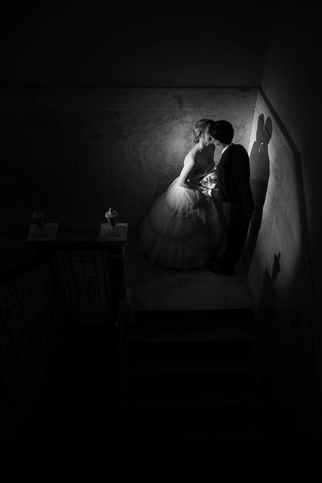 bride and groom kiss on stairs at Atlanta Historic Dekalb Courthouse wedding