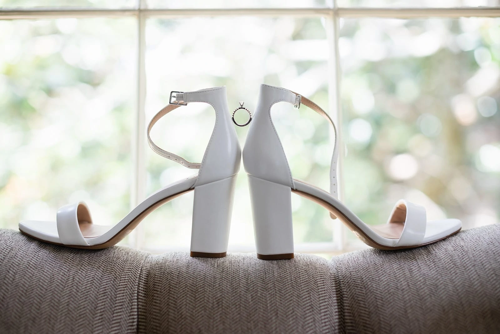wedding ring placed on bride shoes