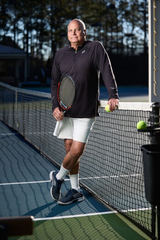 atlanta tennis professional portrait leaning against net